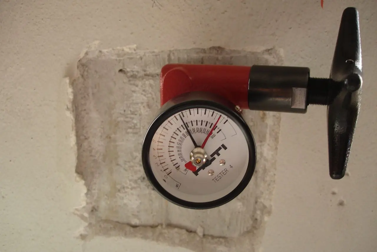 Pull-out test equipment, used to measure concrete strength, on a concrete surface.