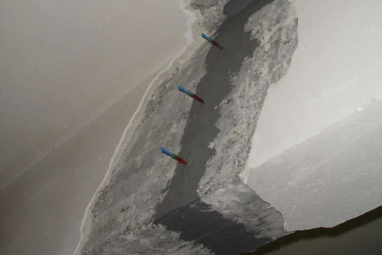 Resin injections in reinforced concrete beam.